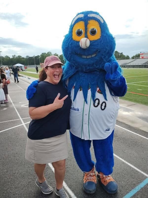 A neighbor enjoys a photo with Riptide of the Norfolk Tides